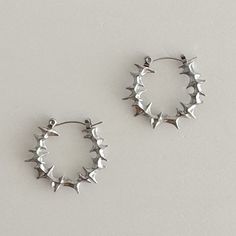 Elevate your style with these bold, spiky stainless steel hoop earrings. 100% stainless steel, 1" diameter. The modern design features small spikes that add an edgy statement to any look. Made from durable stainless steel, these earrings are lightweight and comfortable for all-day wear. Add a touch of contemporary attitude to your ensemble with these standout hoops. We ship in 1-3 days, all purchases come with complimentary jewelry pouch and box. Silver Jewelry Edgy, Grunge Hoop Earrings, Silver Alt Jewellery, Silver Cartilage Earrings, Cool Silver Earrings, Silver Clay Jewellery Ideas, Classy Silver Jewelry, Cute Jewelry Silver, Cool Earrings Unique