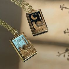 This is a gorgeous 18k, gold plated Sun (Shams) or Moon (Qamar) necklace. The Shams necklace features a beautiful pastel sky nestling a rising sun, surrounded by shimmery gold stars, while the Qamar necklace has a midnight starry sky, with a large gold moon. One of the stars on each necklace is inlaid with a dainty, sparkly gem. A golden masjid rises against the sky, three dimensional and intricately detailed. Below the scene, Shams / Qamar is written in Arabic, set between two tiny stars.  The Sun And Moon Necklaces, Moon Necklaces, Sun And Moon Necklace, Islamic Jewelry, Pastel Sky, Friendship Necklaces, Tiny Star, Gold Moon, In Arabic