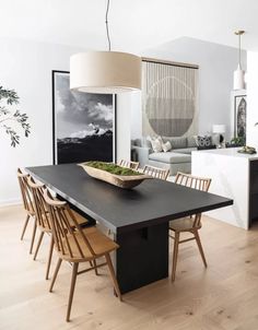 a dining room table with chairs and a bowl on it