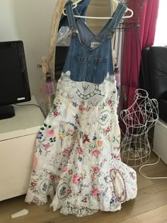 a dress hanging on a rack in front of a window