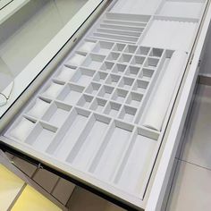 a close up of an open drawer on a counter with drawers in the bottom half