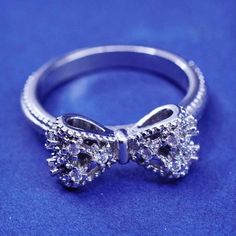 a diamond bow ring on a blue background