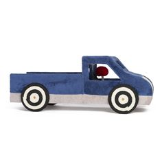 a blue toy truck sitting on top of a white floor