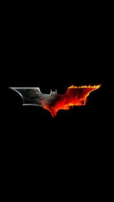 the dark knight logo with flames coming out of it