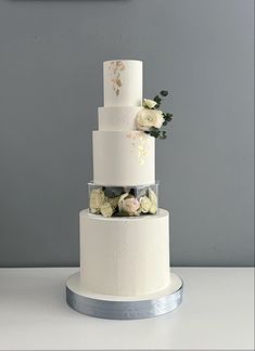 three tiered wedding cake with flowers on top