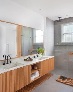 a bathroom with two sinks and a large mirror