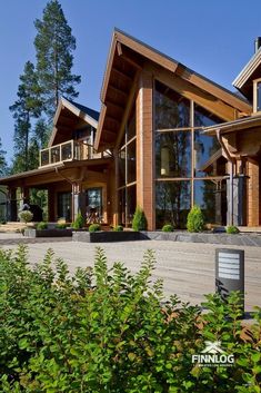 a large wooden house with lots of windows