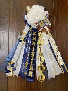 a bunch of ribbons that are on top of a wooden floor with gold and blue decorations