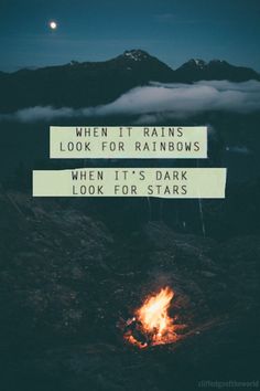 a campfire with the words when it rains look for rainbows, when it's dark look for stars