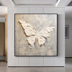 a large white butterfly is hanging on the wall in an empty room with tile flooring