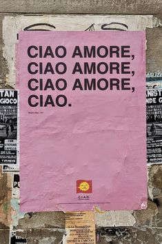 a pink sign on the side of a building that says ciao amore ciao more ciao amore ciao