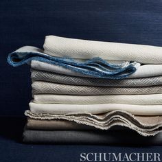 stack of folded linens on top of each other with the words schmaacher