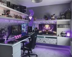 a computer desk with two monitors on it and purple lighting in the room behind it