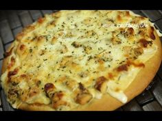 a cheese pizza sitting on top of a metal rack next to an oven grate