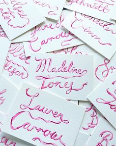 lots of pink calligraphy on white cards