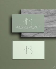 two business cards with the letter b in white and grey on top of each other