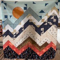 a quilt is hanging up on a table