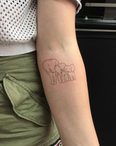 a woman's arm with an elephant tattoo on the back of her left arm