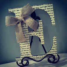 a wooden letter with a bow on it