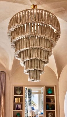 a large chandelier hanging from the ceiling in a room with bookshelves