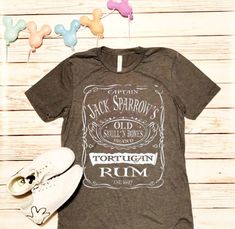 Go to www.itsmyhappyplacetees.com for better pricing. Etsy has raised seller fees so much I had to increase prices. Im happy to offer much better pricing on my website. Have a Magical Day! Argh! Ahoy Matey! Captain Jack Sparrows Tortugan Rum! Welcome to Its My Happy Place! All shirts are made to order, weeded by hand, and pressed with a professional grade heat press. We only use top quality vinyl material. Which will not crack or peel upon washing. But please be sure to follow care instructions. Themed Crew Neck Shirt With Pre-shrunk Details, Themed Crew Neck Shirt Pre-shrunk, Themed Pre-shrunk Crew Neck Shirt, Disney World Shirt, Disney Cruise Shirts, Disneyland Shirt, Disney Shirts For Men, Disney Trip Shirts, Diy Disney Shirts