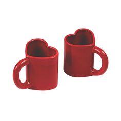 two red heart shaped mugs sitting next to each other