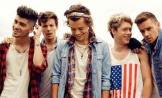 group of young men standing next to each other with an american flag on their shirt