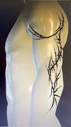 a white mannequin with vines on it's back