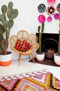 a living room filled with lots of potted plants next to a fire place and fireplace