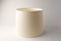 a white lamp shade sitting on top of a table