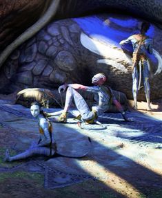 three mannequins are sitting on the ground in front of a rock formation