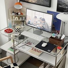 a glass desk with a computer on it