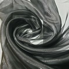 black and white photograph of fabric with metallic foiling on the bottom, as if it were an art project