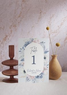 there is a card with the number one on it and two vases next to it