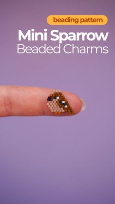 a tiny beaded charm on the thumb of a person's finger with text reading mini sparrow beaded charms