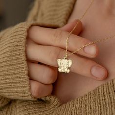 "* Material: High Quality 14K Solid Gold - Not Gold Vermeil Not Gold Plated - ( REAL SOLID GOLD ) * Metal Stamp: 14k * All our jewelry is custom made by hand with Love and Care in our workshop * 14k Solid Gold Elephant Necklace - Tiny Baby Elephant Pendant - Dainty Animal Necklace - Elephant Jewelry - Gift For Her - By Demir Uluer H O W ∙ T O ∙ O R D E R * You can choose the color of your pendant using the first box / option * You can choose the length of your chain by selecting the second option / box. * Just use the 'PERSONALIZATION BOX' to let us know the Note you want on the back of your Pendant O T H E R ∙ I N F O R M A T I O N * Material of chain: 14K Solid gold ( REAL GOLD ) It is thin and dainty and it is available in 6 sizes: - 35 cm / 13,75 inches ( Length ) - 40 cm / 15,75 inche Handmade Pendant Charm Necklaces For Birthdays, Handmade Pendant Charm Necklaces For Birthday, Handmade Pendant Charm Necklace For Birthday, Handmade Yellow Gold Necklaces For Birthdays, Cute Handmade Gold Necklaces, Handmade Yellow Gold Jewelry For Birthday, Handmade Yellow Gold Necklace For Personalized Gift, Cute Handmade Necklaces For Personalized Gifts, Gold Animal Design Necklace For Gift