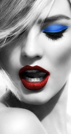 a woman with bright blue and red makeup