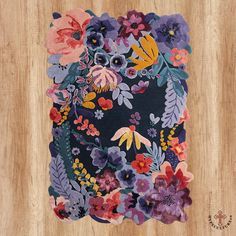 an animal made out of flowers on a wooden surface