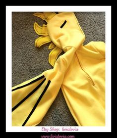 a yellow dragon costume laying on the floor