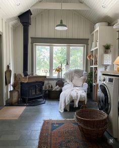 a living room with a washer and dryer in it