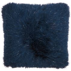 the blue fur pillow is on display against a white background