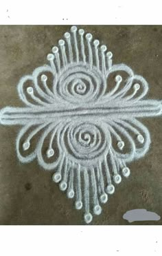 an intricately designed design on the ground with circles and spirals in white paint