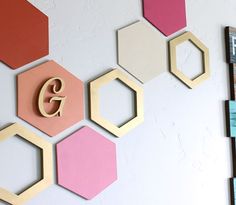 the wall is decorated with hexagons and wooden letters