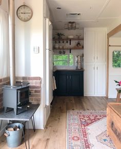 a kitchen area with a stove, microwave and cabinets