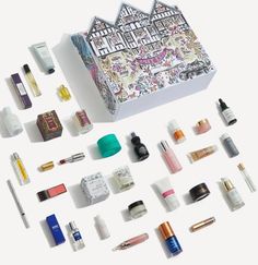 an assortment of cosmetics and beauty products laid out on a white surface