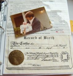 a birth certificate sitting on top of a binder