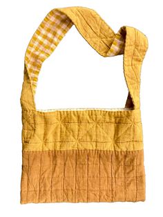 an orange and yellow bag with a checkered scarf hanging from it's side