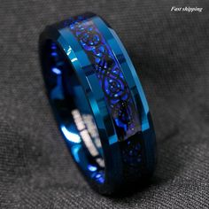 Blue Dragon Wedding Band | Black Celtic Tungsten  Ring | Dragon Wedding Band | Dragon Ring Men | Anniversary Ring | Mens Ring Whether it's for a wedding, a special occasion, or just as a stylish accessory, this ring is sure to leave a lasting impression. Elevate your style and stand out from the crowd with this unique piece that seamlessly combines tradition with contemporary flair. We attach importance to all orders and promise to ship them as soon as possible. Orders are very valuable to us, we know that they are eagerly awaited. Return and exchange card for rings : https://www.etsy.com/listing/1732734064/size-exchange?click_key=5b8010b65949bd37d04b8a458e8c6acda8e4e03d%3A1732734064&click_sum=93cb7de8&ref=shop_home_active_1&pro=1&frs=1 Thank you for your time and visiting our small family Ring Carbon, Rings For Men Wedding, Dragon Blue, Wedding Bands For Him, Celtic Dragon, Tungsten Carbide Wedding Bands, Rings Mens Wedding Bands, Blue Ring, Tungsten Carbide Rings