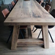 a large wooden table with chairs around it