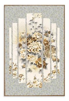 a wall hanging with flowers and pine cones on the front, in gold and white